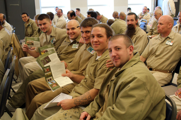 Lecture series students show off their SPP information sheets; we have recently increased our outreach inside Washington State's prisons. Photo by Tiffany Webb.