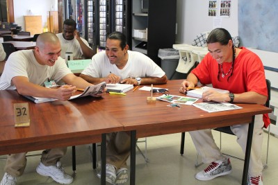 Students in the Roots of Success class at Cedar Creek Corrections Center work in a small group to address a study question. Photo by Erica Turnbull. 