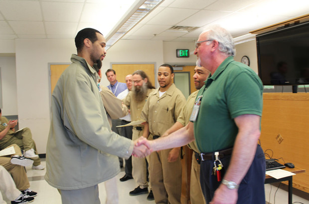 Thirty five graduates of Roots of Success receive their certificates and handshakes from Mr. Aleksinski, the three inmate instructors, Superintendent Glebe, SPP Liaison Chris Idso, and SPP Conservation Nursery Coordinator for SCCC Drissia Ras. 