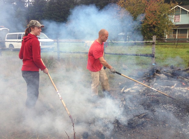 CNLM's Audrey Lamb and an inmate on the prairie conservation crew rake fire through the demonstration garden.