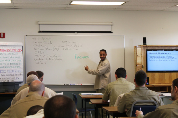 Instructor Walrond writes students’ answers during discussion of perceived obsolescence