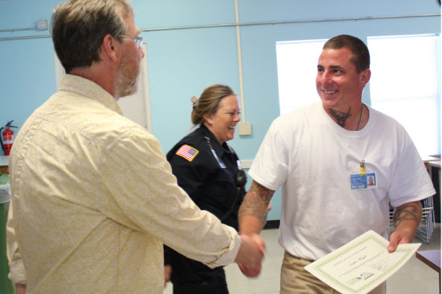 Inmates on Cedar Creek Corrections Center’s Prairie Restoration Crew, past and present, receive recognition for their efforts over the past year in a graduation ceremony at the corrections center.