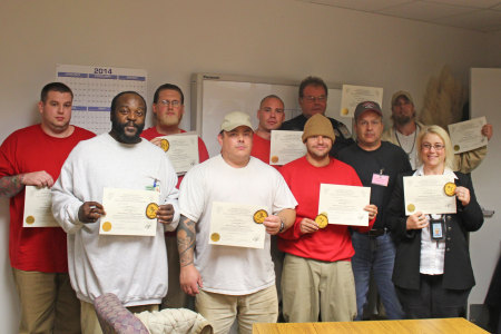 The first class of certified beekeepers at Cedar Creek Corrections Center pose with their certificates. Photo by Fiona Edwards.