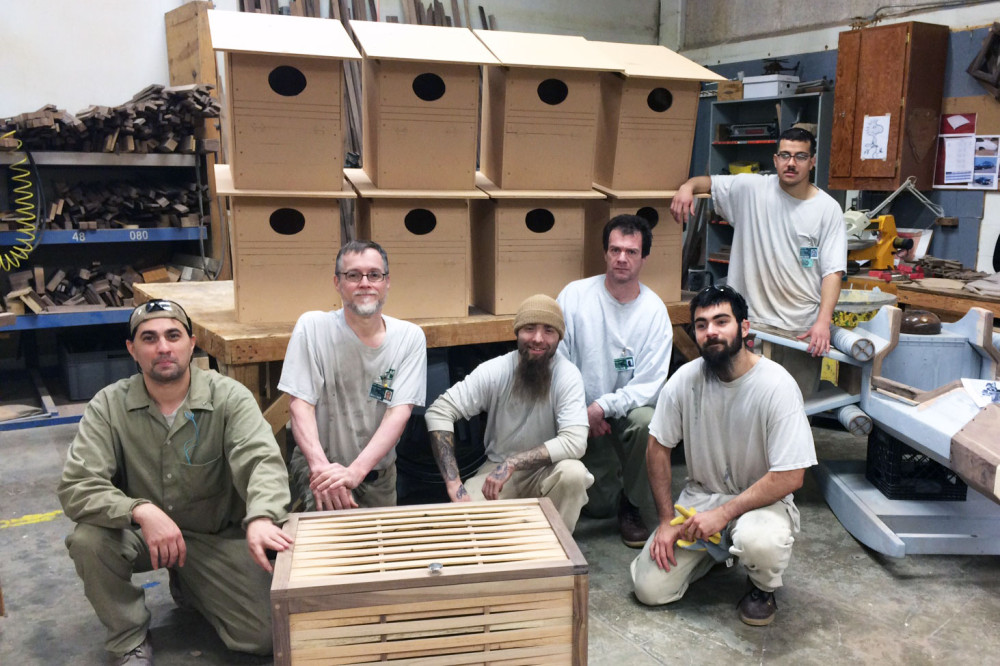 Roy Townsend, Michael Feeney, Robert Beck, Robert Haugen, Luke Andrade, and Jose Ayala pose with the barn owl next boxes they build in the Sustainable Practices Lab. Photo by DOC staff. 