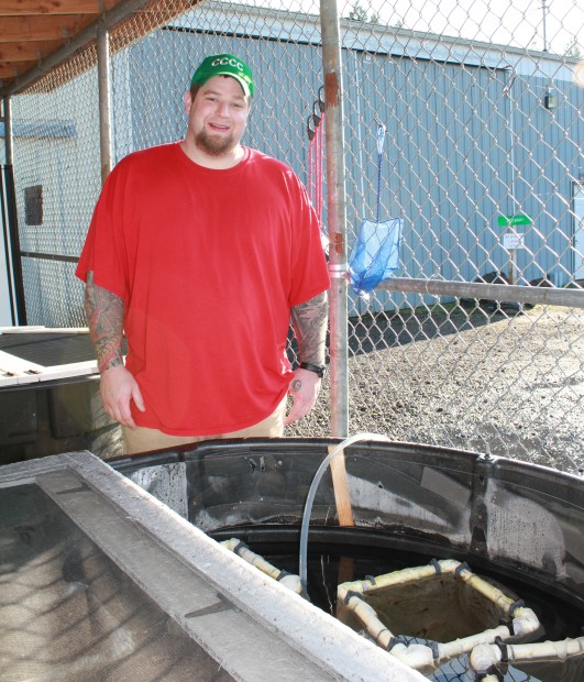 Mr. Boysen cleaning the OSF tank full of tadpoles at Cedar Creek Corrections Center