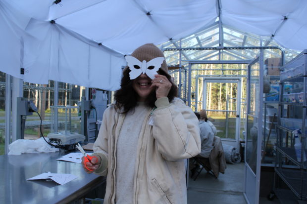 Susan Christopher making butterfly masks for Girls Scouts Behind Bars visiting the Butterfly Greenhouse. 
