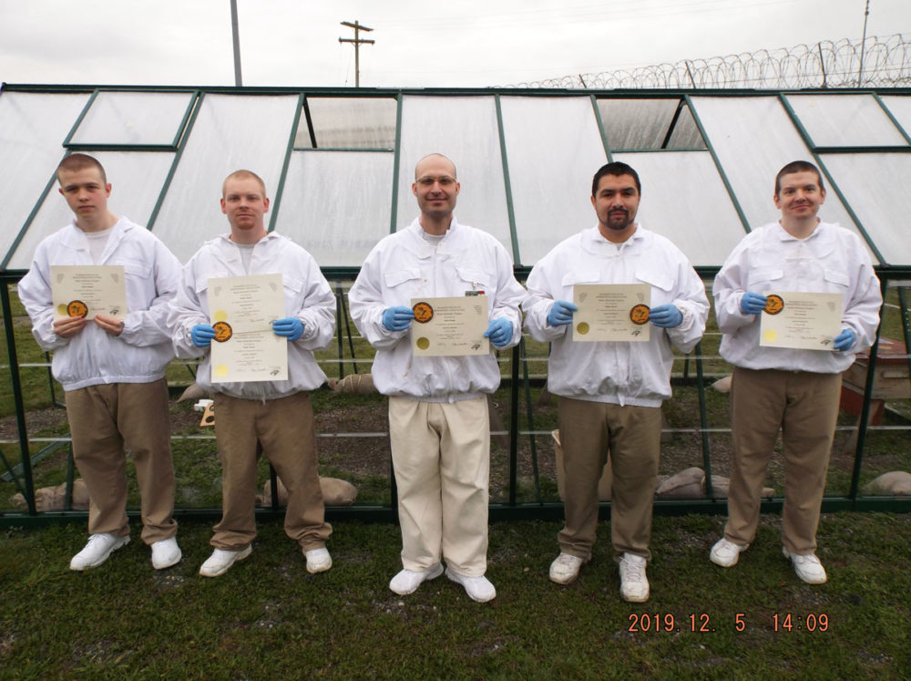 Beekeeping graduates pose with their certificates in the MCC-Special Offender Unit program. Photo by Kathy Grey.