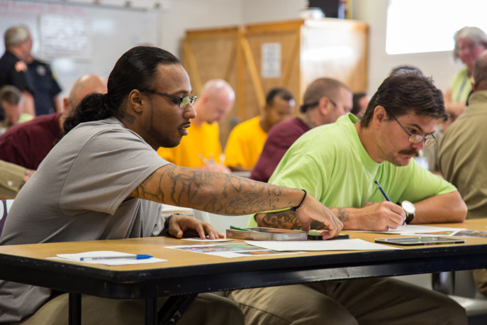 Students draw plants and butterflies during a workshop at Airway Heights Corrections Center. Photo by Ricky Osborne.