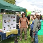SPP intern Jaal Mann sharing the information at our booth with interested animal lovers at Save the Frogs Day 5K in Seward Park.