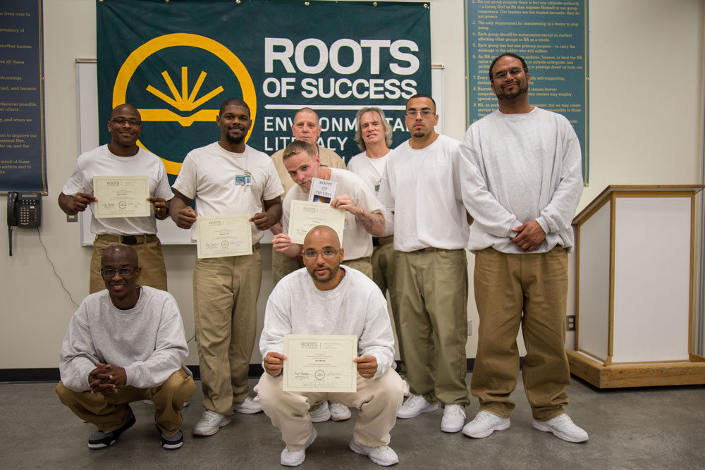 A class of Roots of Success graduates and their instructor pose during a graduation ceremony at Coyote Ridge Corrections Center. Photo by Ricky Osborne.