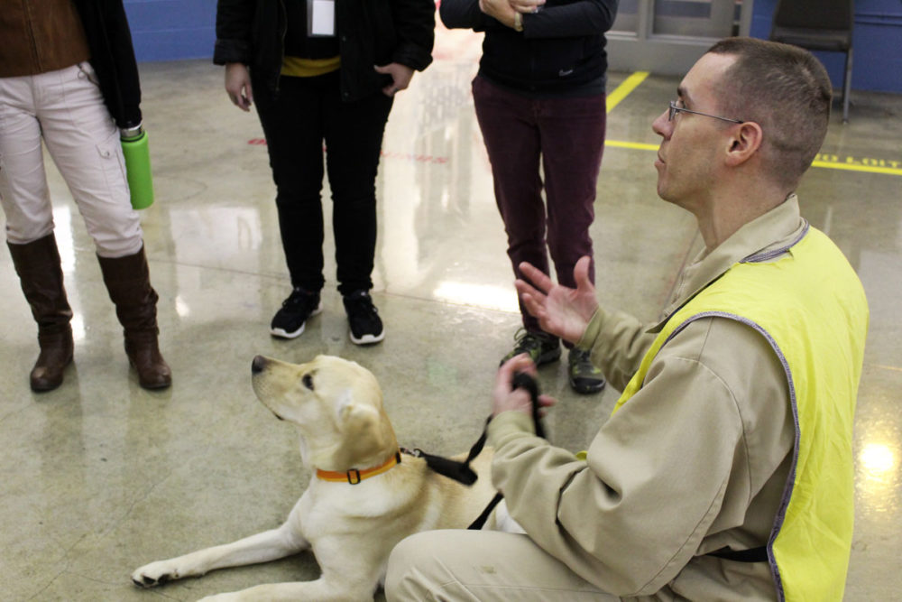 A dog handler answers visitors' questions. Photo by Joslyn Rose Trivett. 